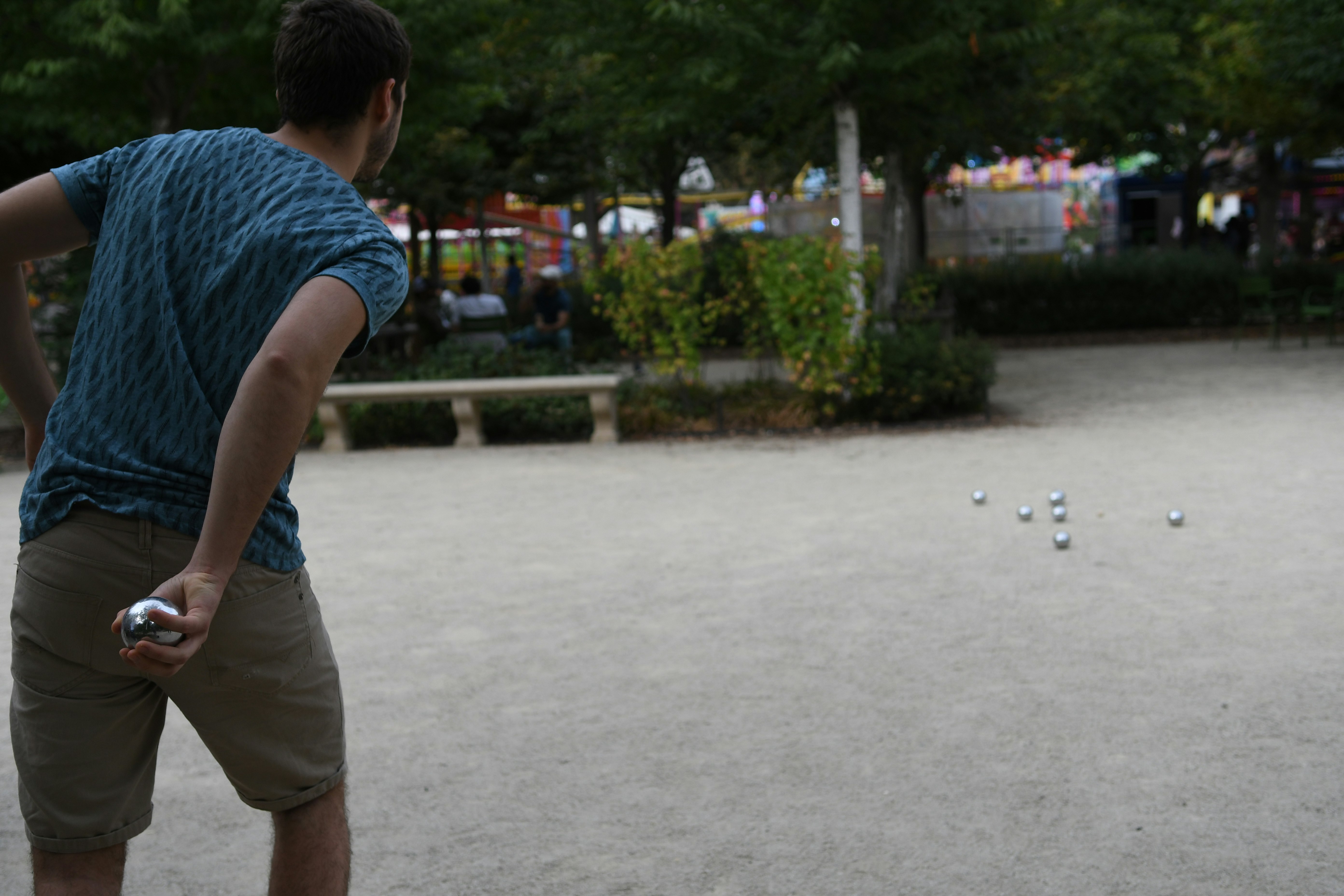 man throwing gray steel ball